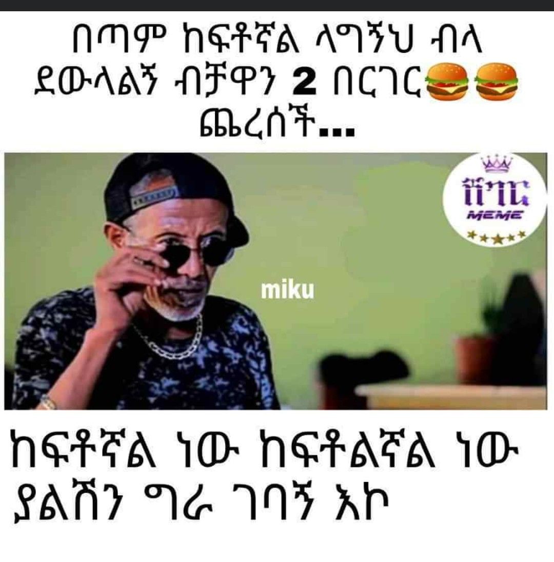 a man in a black hat and sunglasses talking on a cell